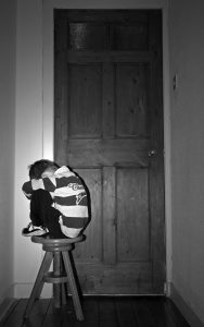 ashamed boy on stool